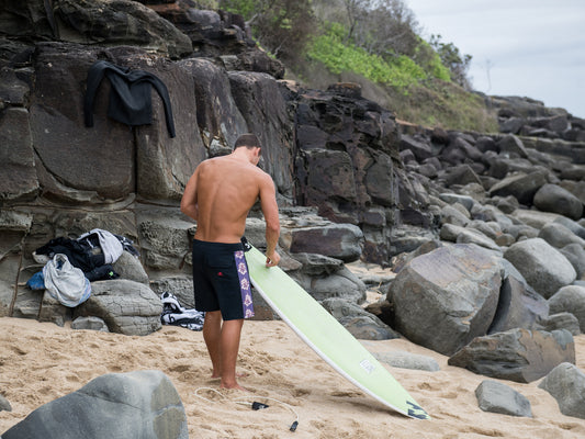 waxing a surfboard